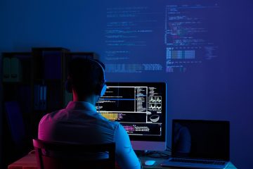 A software developer working in a dimly lit environment, analyzing complex code on multiple screens with automation tools and data analytics.